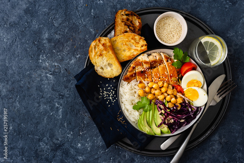 Buddha bowl Rice chickpeas chicken breast eggs vegetables Top view with copy space