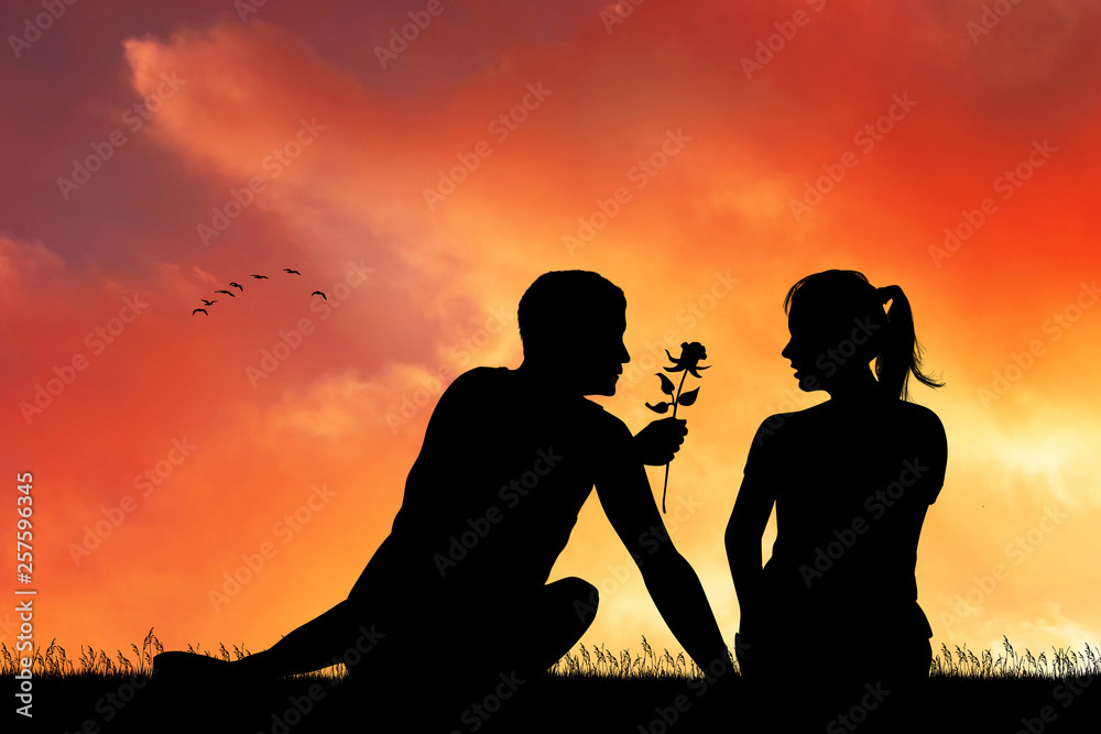 man gives the rose to his girlfriend at sunset