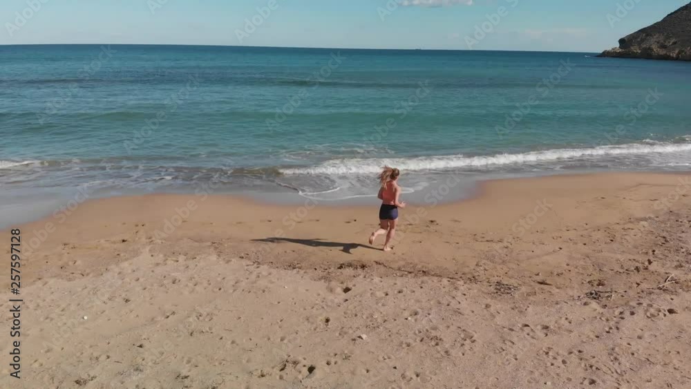 young sportswoman girl running on the beach young sportswoman girl running on the beach