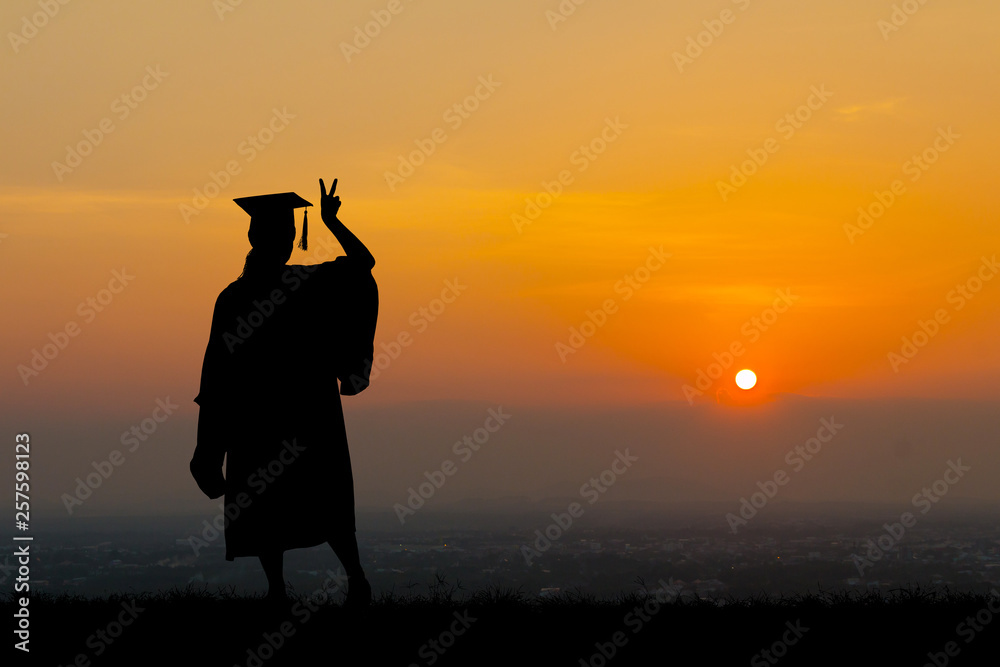 Fototapeta premium Silhouette education graduation student success learning concept at sunset.