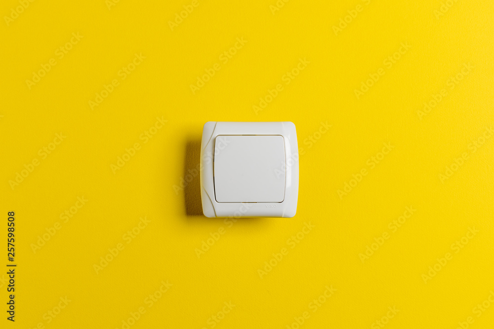 light switch on a bright yellow background Stock Photo | Adobe Stock