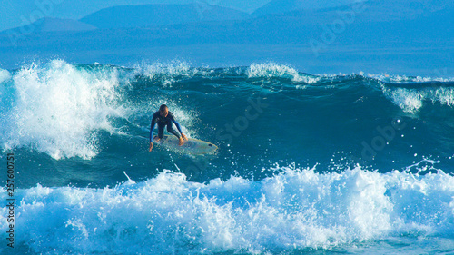 Photography Big barrel wave pushes the young surfer towards the coastline of Canary Islands