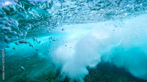 UNDERWATER: Bubbles rise from the depths after barrel wave rushes over camera