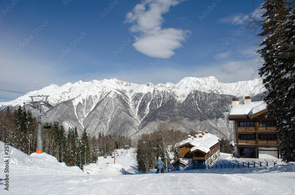 Scenic view of mountain slopes and apartments at ski resort Laura Russia