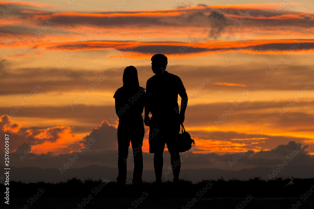 Silhouette young couple on sunset time.