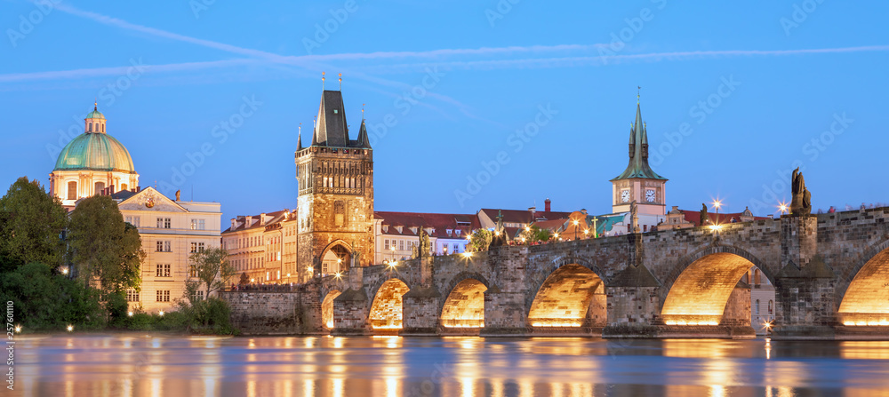 Fototapeta premium Scenic view Charles bridge and historical center of Prague, buildings and landmarks of old town at sunset, Prague, Czech Republic