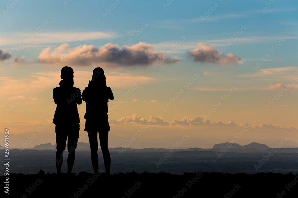 Silhouette young couple on sunset time.