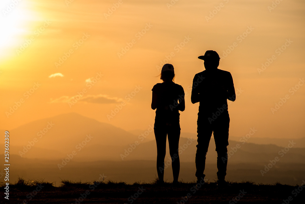 Silhouette young couple on sunset time.