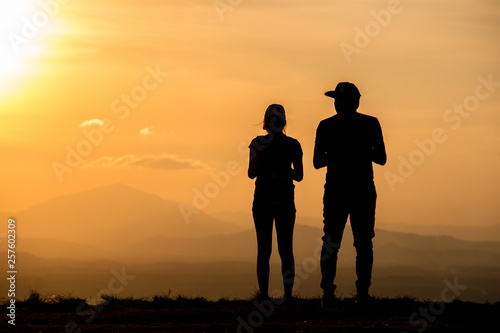 Silhouette young couple on sunset time.