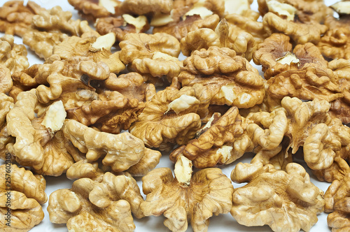 Walnuts on natural burlap, walnut kernels in a wicker basket, nutty background