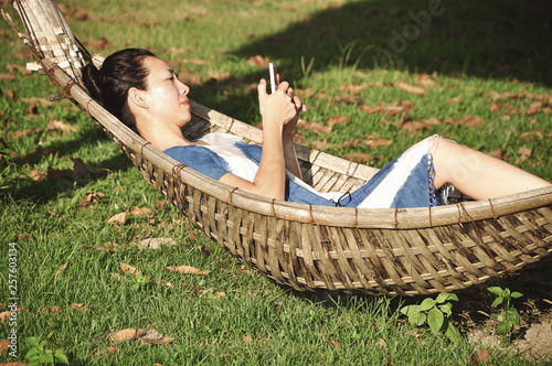 woman use smartphone on cradle bamboo