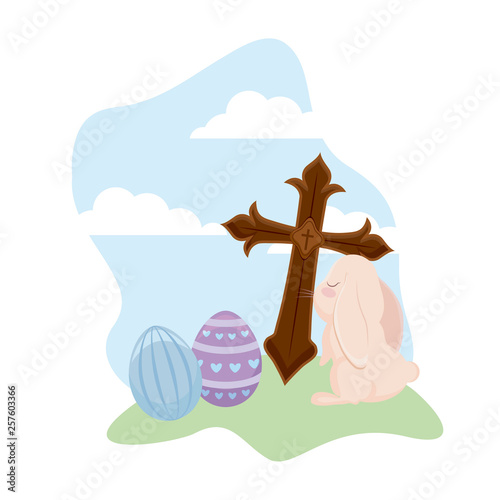 cute rabbit with eggs of easter and cross catholic