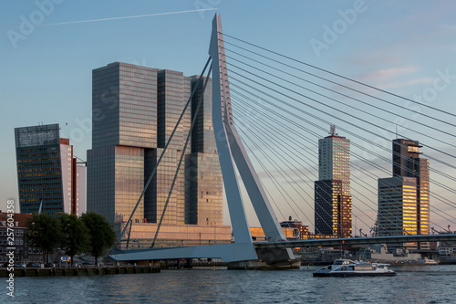 Rotterdam financial district skyline with the famous Erasmus bridge and modern skyscrapers at golden hour sunset