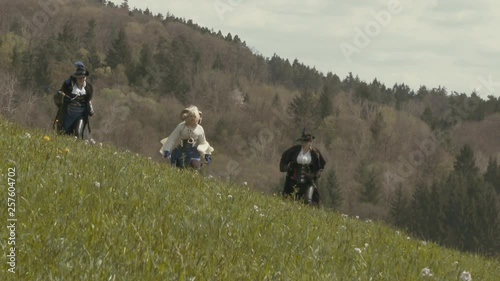 Fantasy Adventure Group running on meadow – Slow Motion photo