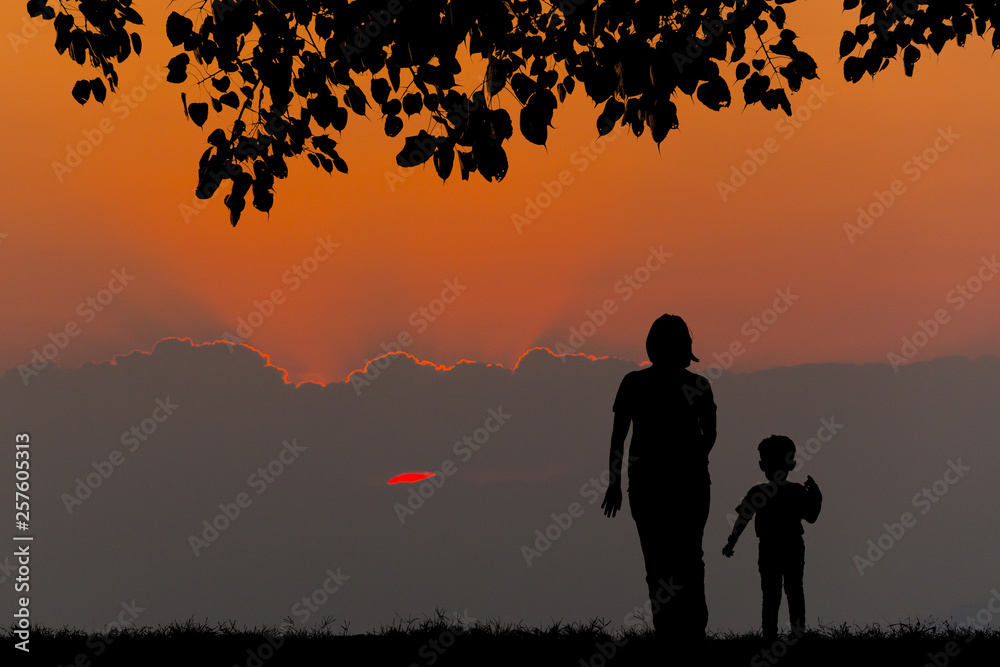 silhouette of a happy family with children on sunset time