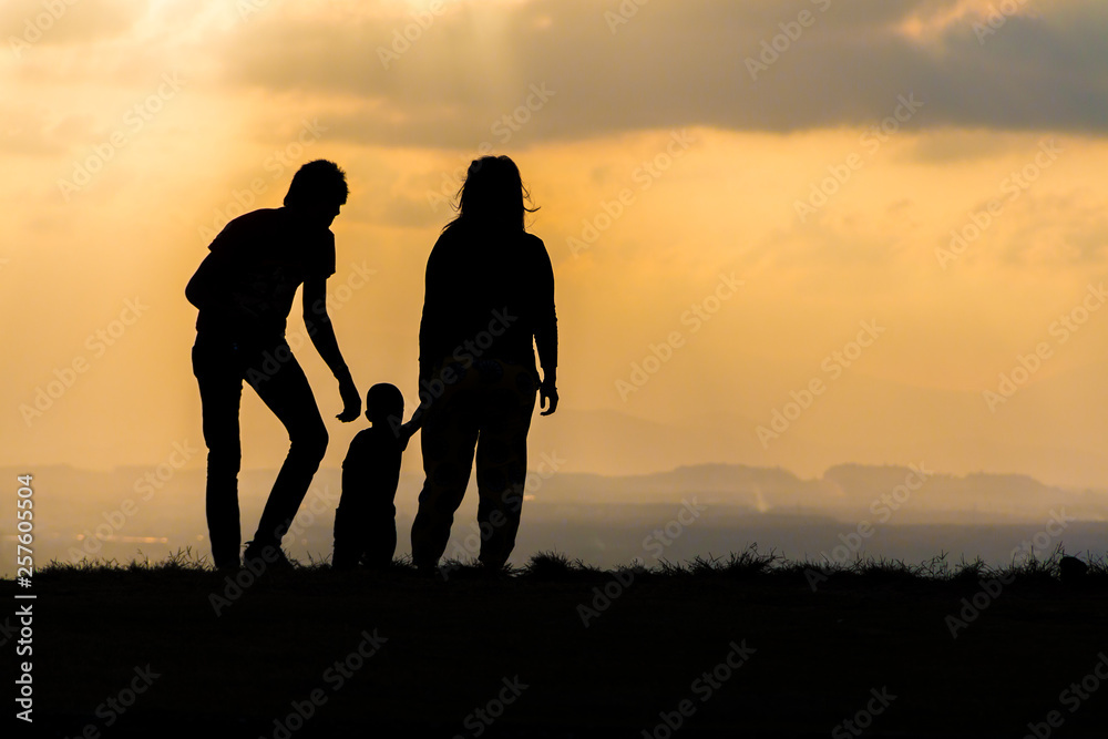 silhouette of a happy family with children on sunset time