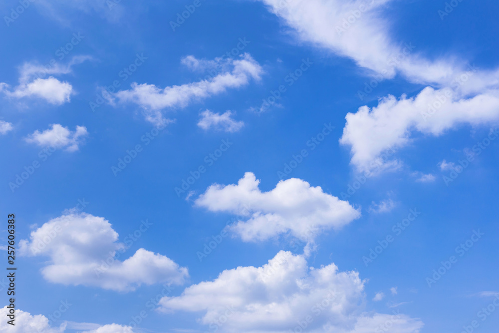 Blue sky background with white clouds, rain clouds on sunny summer or spring day.