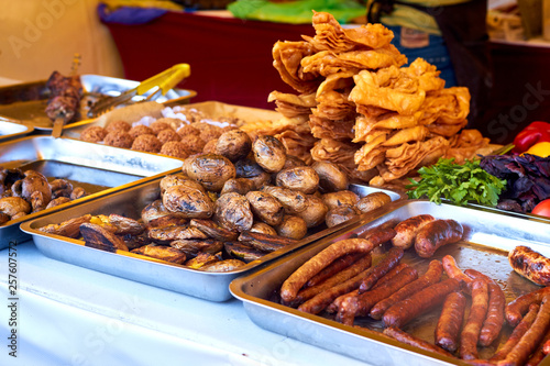 Baked potatoes, mushrooms and sausages at the food fair © watcherfox
