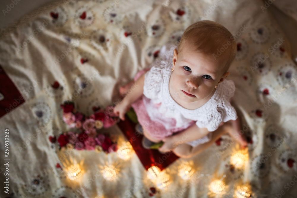 Cute girl child in gentle dress, top view. Garland Cute girl child in gentle dress, top view. Garland