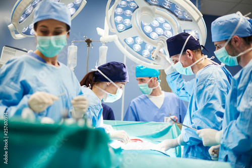Group of surgeons in operating room photo