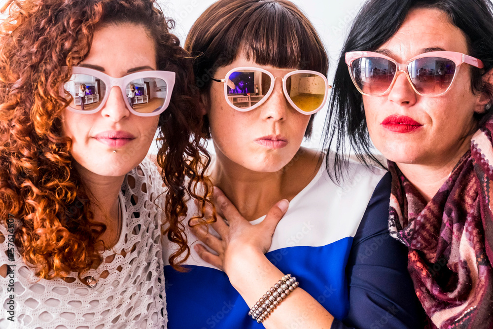 Group of three girls friends toegther with fashion style and coloured sunglasses doing funny expression - portrait of freidnship concept for young women - Group of three girls friends toegther with fashion style and coloured sunglasses doing funny expression - portrait of freidnship concept for young women -