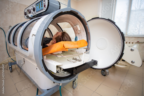 young guy in a hyperbaric chamber, oxygen treatment, medical chamber