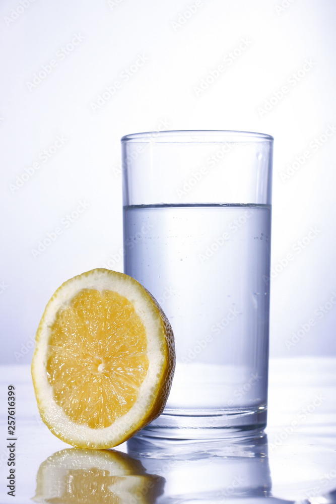 Glass of water and a slice of lemon Glass of water and a slice of lemon