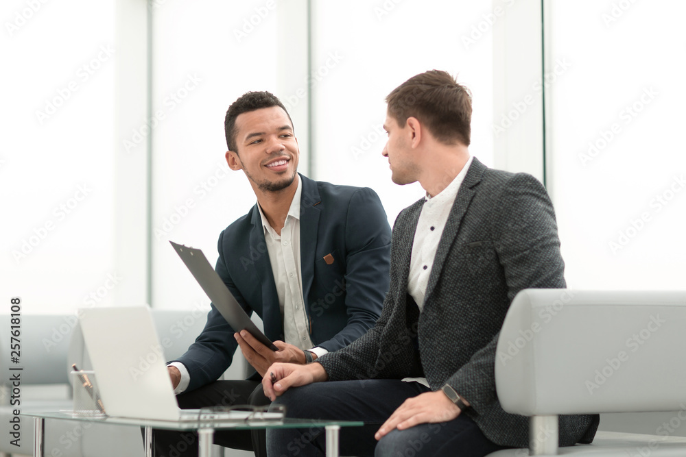 two business people discuss business documents at a meeting in the office two business people discuss business documents at a meeting in the office