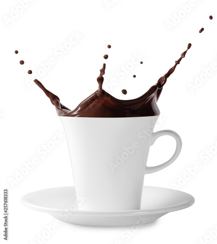 Splash of black chocolate in white cup with saucer
