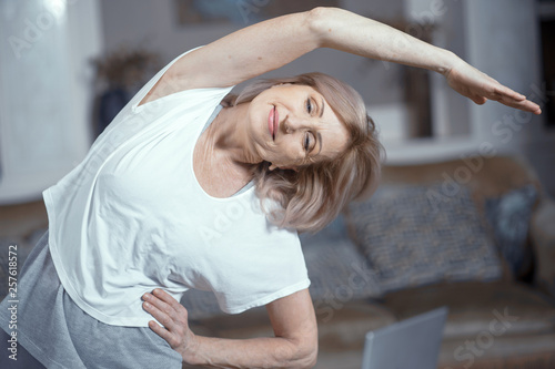 Middle aged woman doing yoga at home