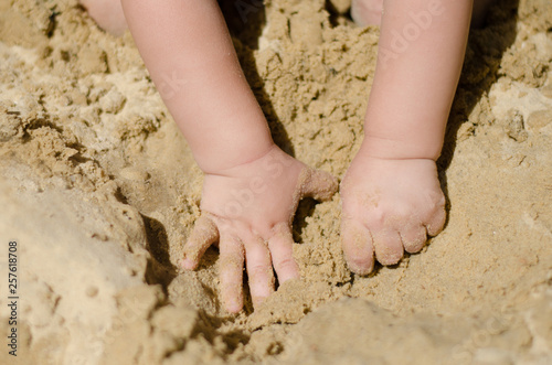 the child is digging in the sandbox
