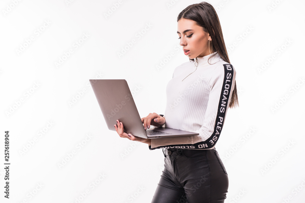Young girl in casual clothes holding laptop isolated on white background Young girl in casual clothes holding laptop isolated on white background