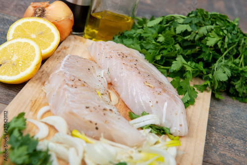 Fresh fish, raw cod fillets with addition of herbs and lemon
