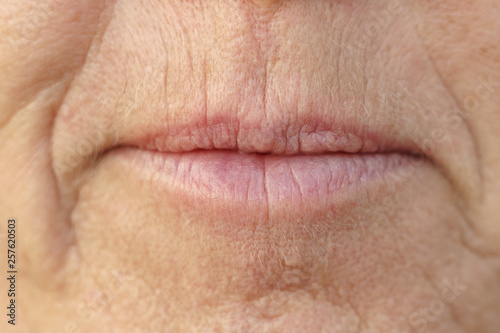 Extreme Closeup on the mouth of a middle-aged woman
