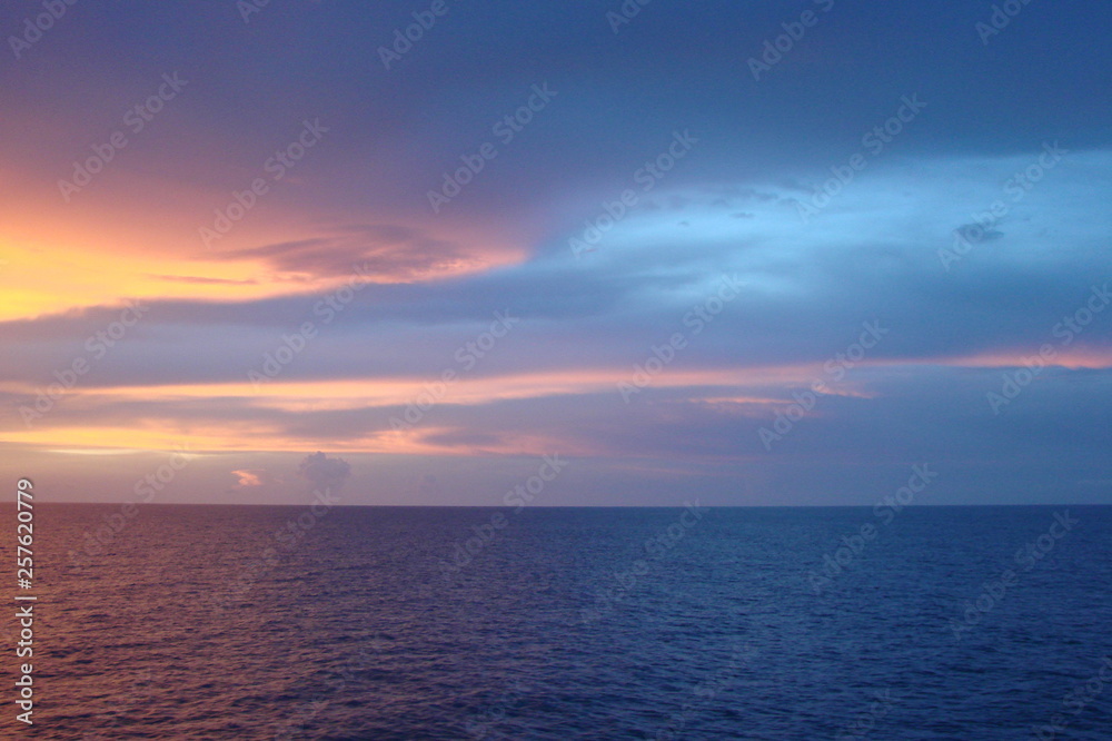 The landscape from the deck of the ocean liner is incredible beauty of the bright natural scenery of the sunset on the sea horizon.