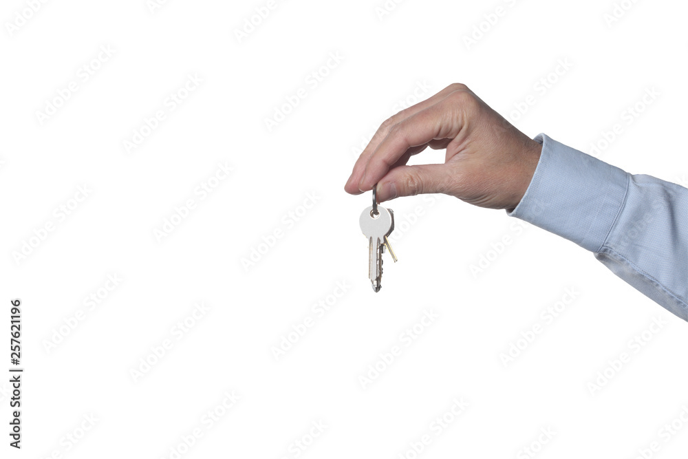 real estate concept: man's hand holding keys isolated on white background with clipping path included and copy space for your text real estate concept: man's hand holding keys isolated on white background with clipping path included and copy space for your text