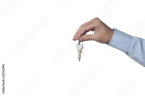 real estate concept: man's hand holding keys isolated on white background with clipping path included and copy space for your text