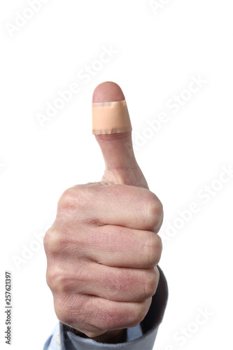 male man showing thumb with a plaster isolated on white background with clipping path and copy space for your text