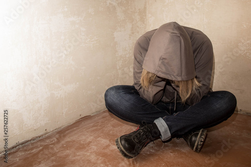 Portrait of man sad, drug addict man sitting on the floor in corner
