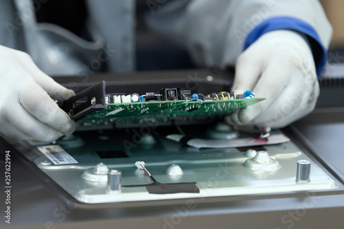 Assembly of printed circuit boards for TV sets at the factory photo