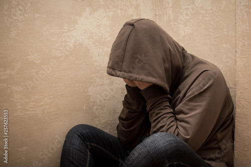 Portrait of man sad, drug addict man sitting on the floor in corner