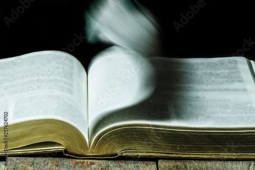 Bible pages motion blurry flipping, still life art slow shutter speed photography photo