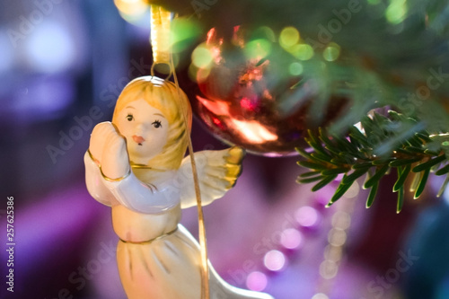 Christmas tree. Christmas decorations: balls, lights, angel figure.