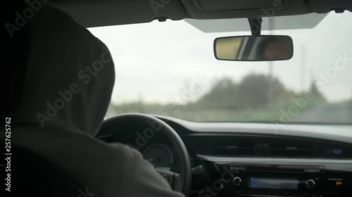 Shot of the men driving a car in countryside. photo