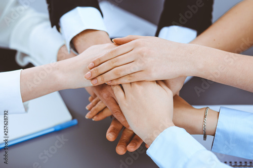 Business people group joining hands and representing concept of friendship and teamwork