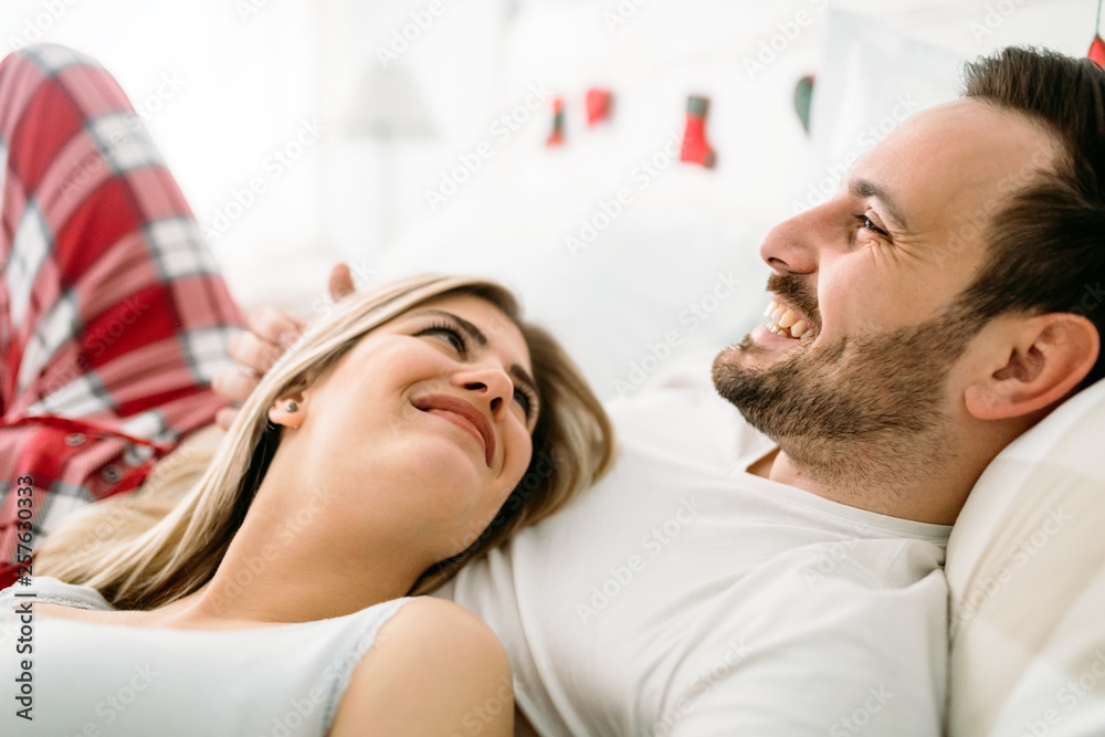 Fototapeta premium Portrait of young loving couple in bedroom