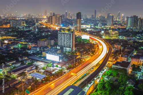 Cityscape of Bangkok city with low and hight building along the street with sky train on rail way. © tisomboon