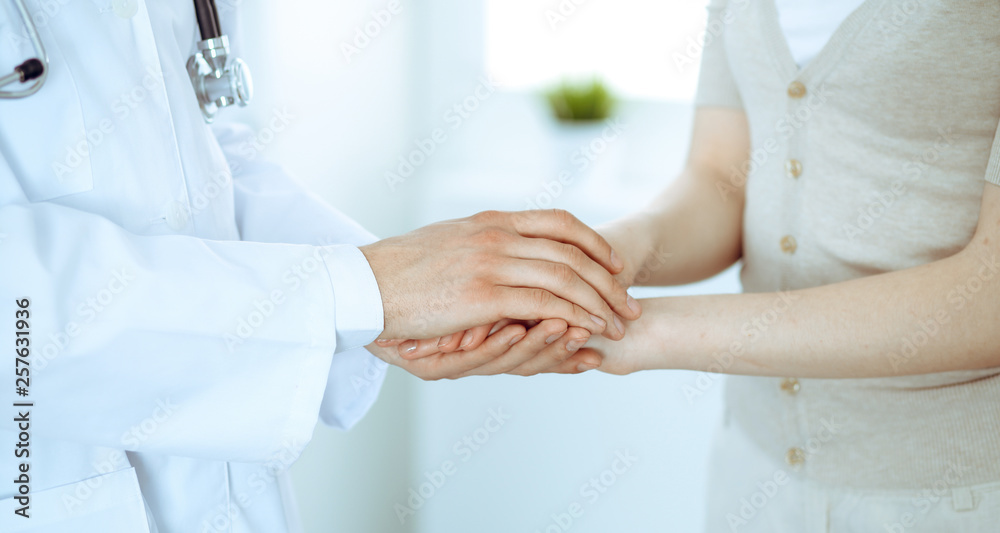 Hand of doctor reassuring her female patient. Medicine and health care concept Hand of doctor reassuring her female patient. Medicine and health care concept