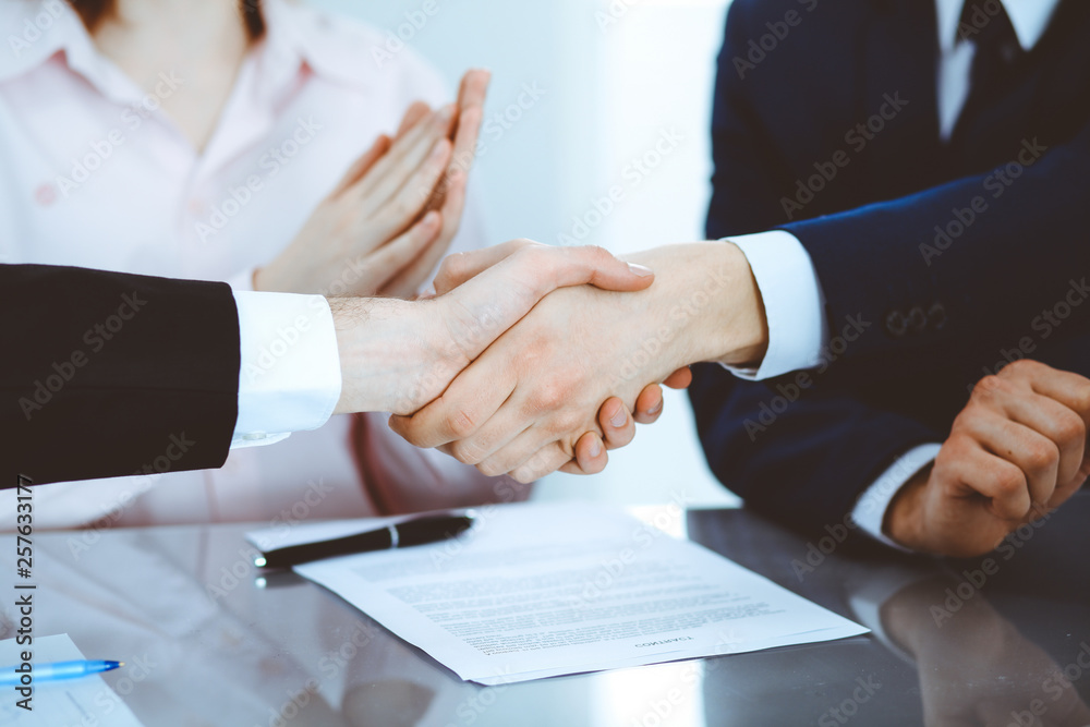 Business people shaking hands finishing up a meeting. Handshake at successful negotiation