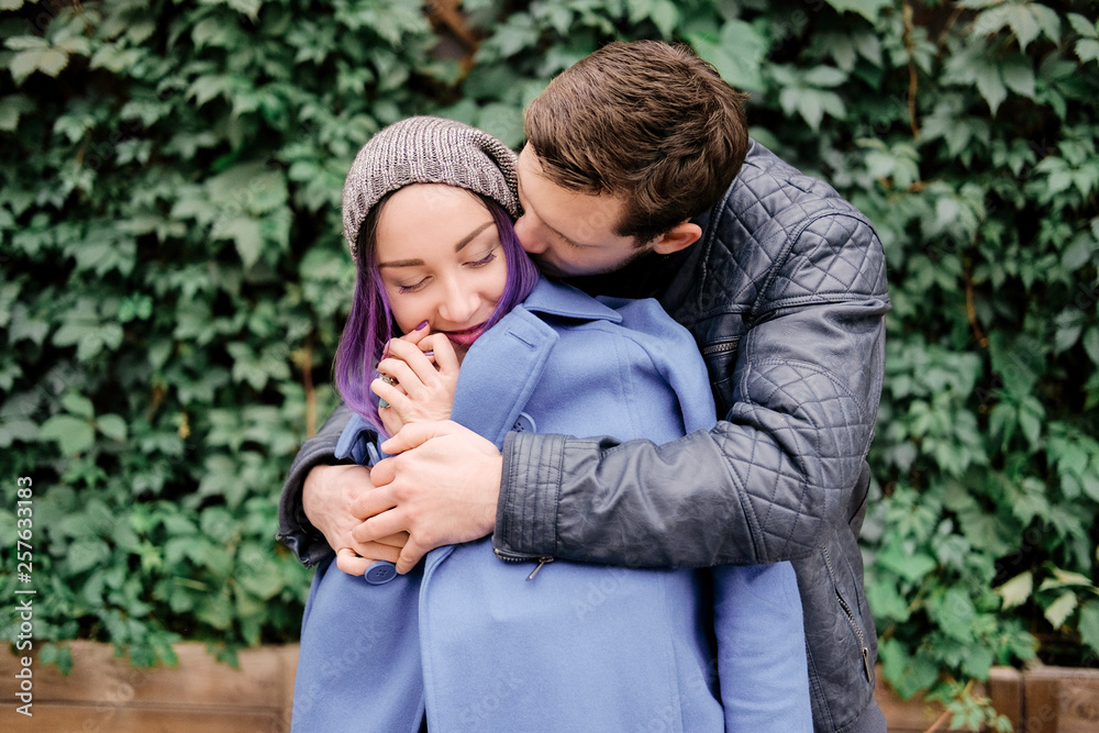 A couple in an embrace in the street. Smiling lovers. A couple in an embrace in the street. Smiling lovers.